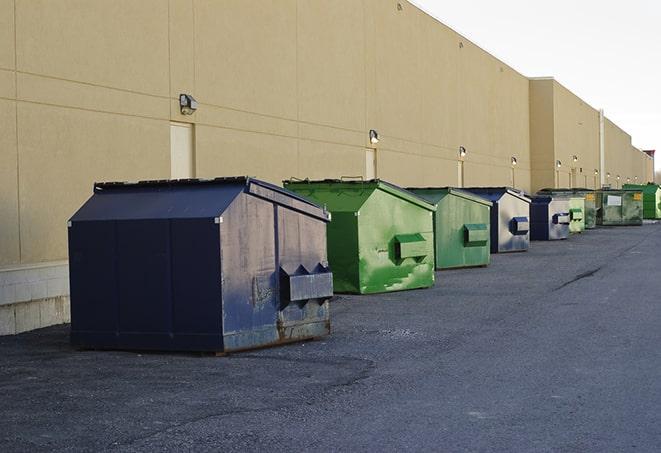 a row of construction dumpsters parked on a jobsite in Dacula, GA